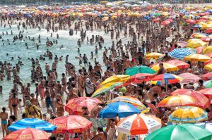 People from all ages taking time to relax in the waters of Copacabana, the Brazilian most famous beach in the world.
